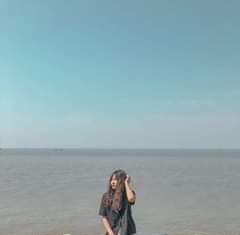 May be an image of 1 person, standing, sky and ocean
