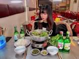 May be an image of 1 person, hot pot and indoor