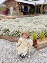 May be an image of child, flower and outdoors