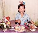 May be an image of child, sitting, standing and cake